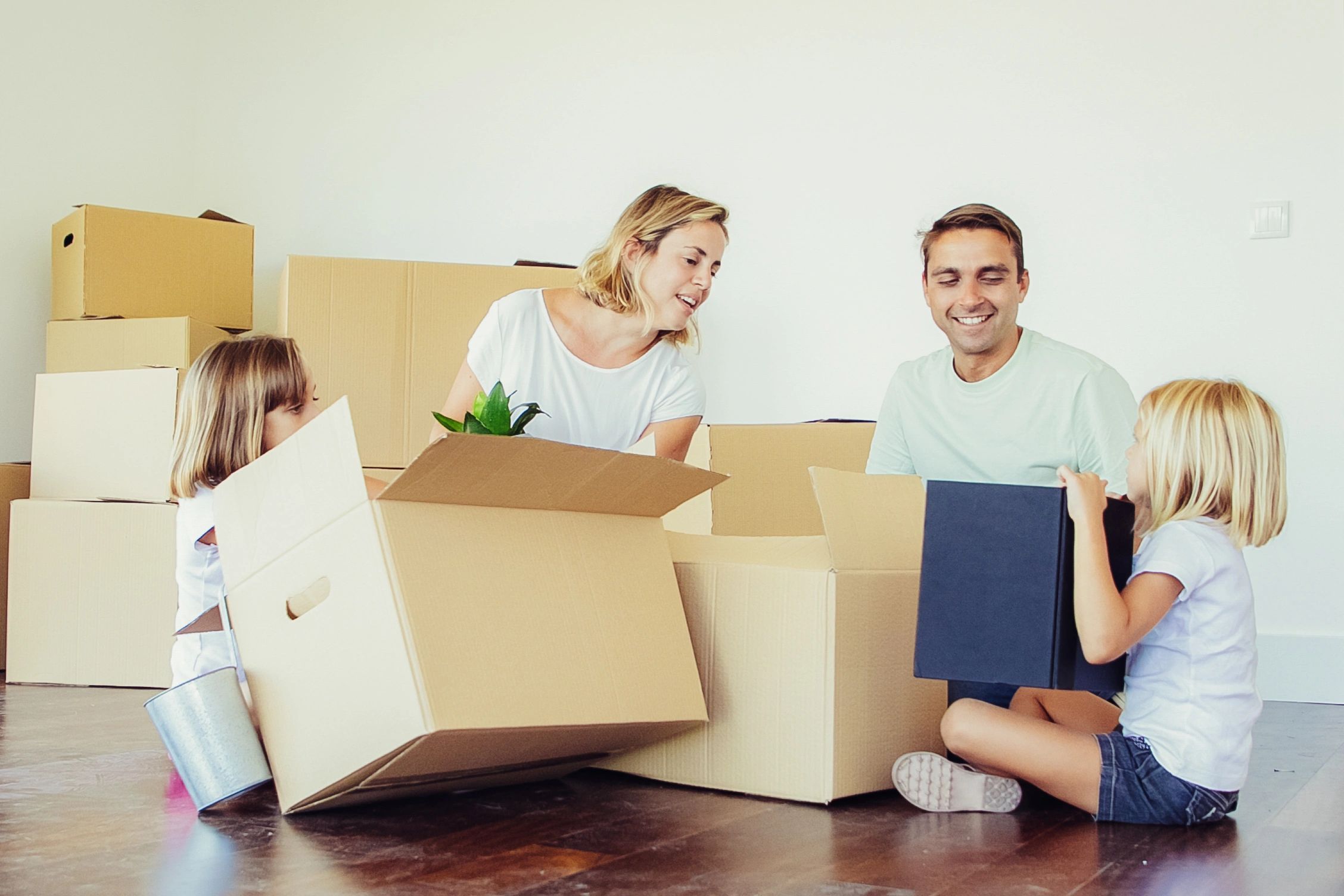 Family unpacking boxes in a new home