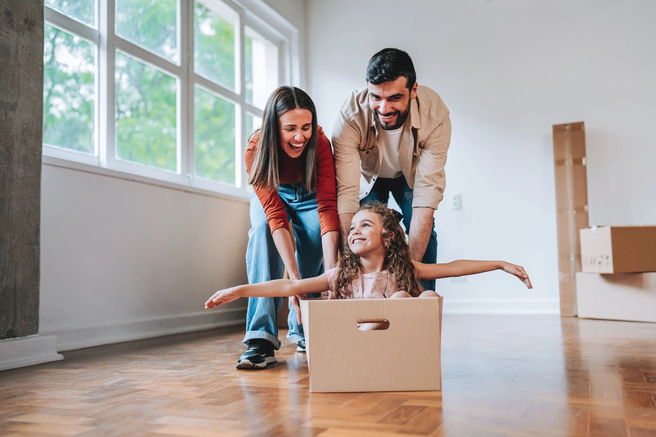 Family surrounded by moving boxes in a new home