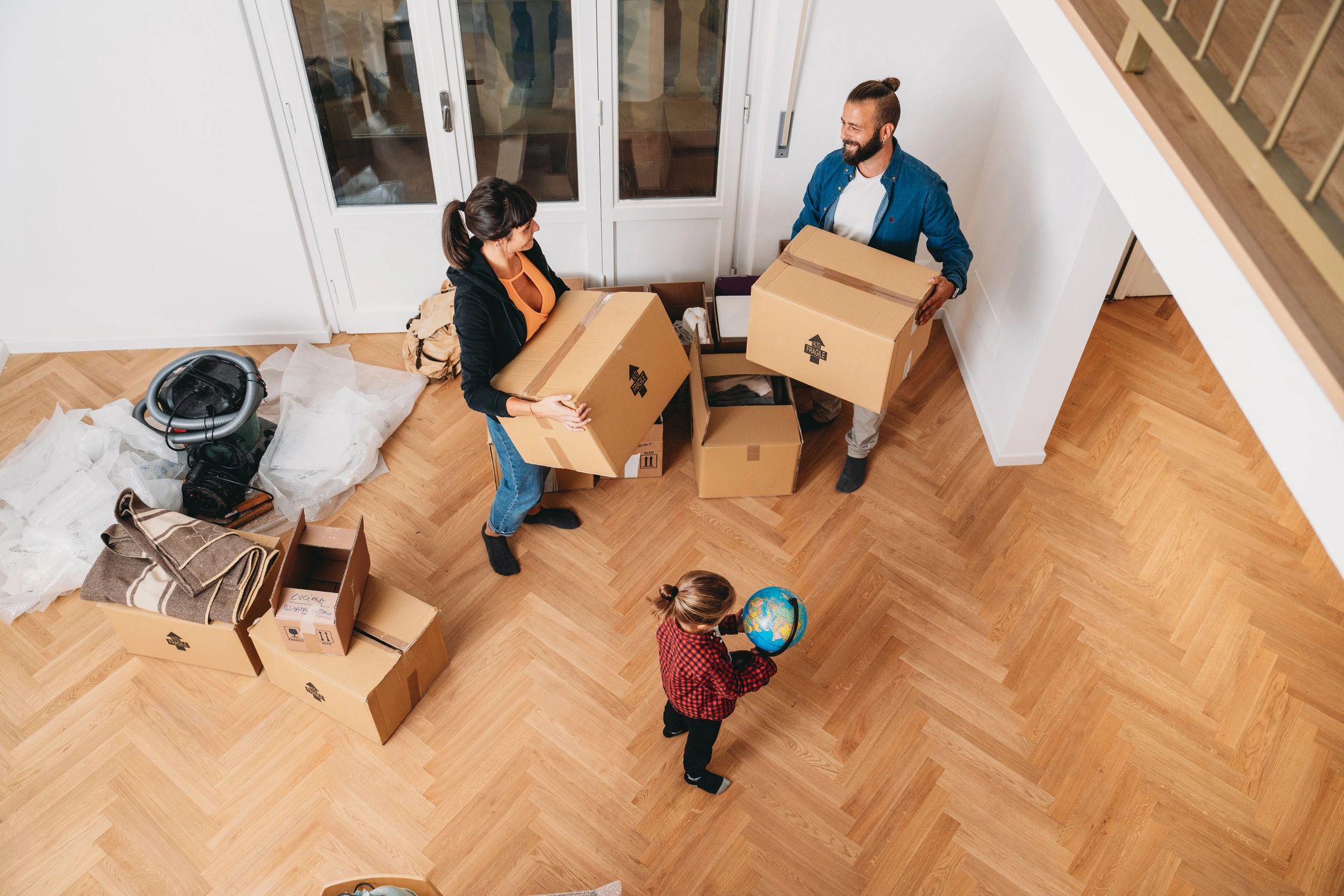 Family moving into a new home with cardboard boxes