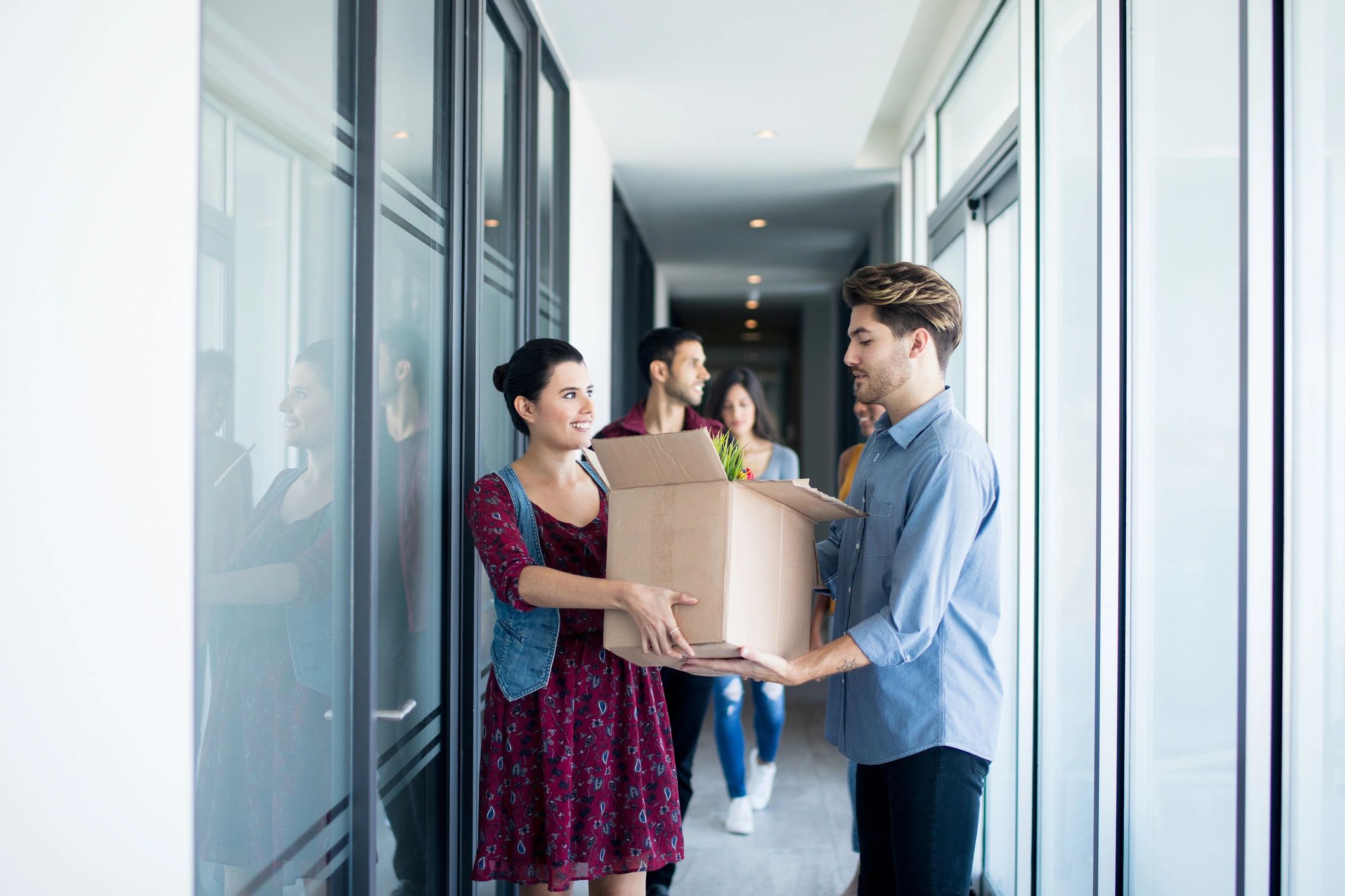 Team carrying packed boxes during an office relocation
